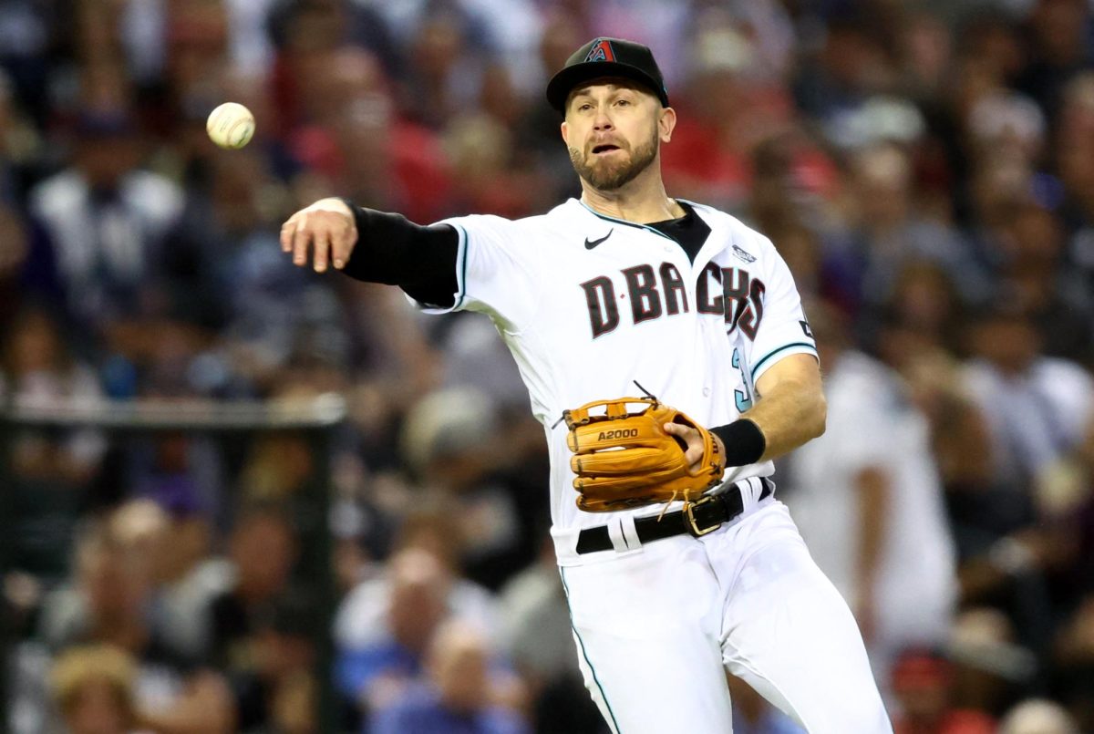 Oct 30, 2023; Phoenix, AZ, USA; Arizona Diamondbacks third baseman Evan Longoria (3) throws to first for an out during the sixth inning in game three of the 2023 World Series against the Texas Rangers at Chase Field. Mandatory Credit: Mark J. Rebilas-USA TODAY Sports