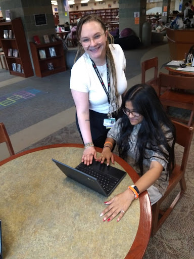 FLMC aide Ava Schickel works with Krupa Patel in the library during 3rd period.