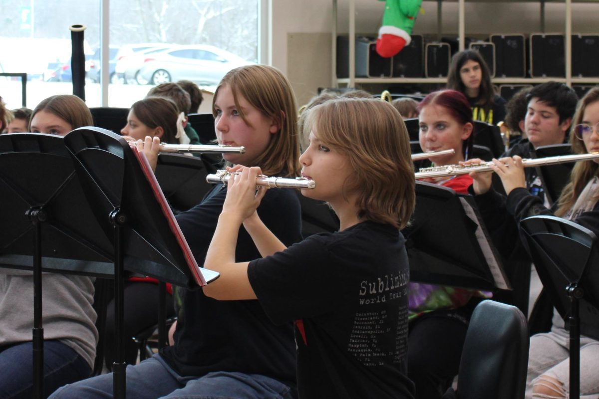Freshmen flutists Lilly Leuthold and Emerson Alvey practice during sixth period band class for Winter Fantasia.