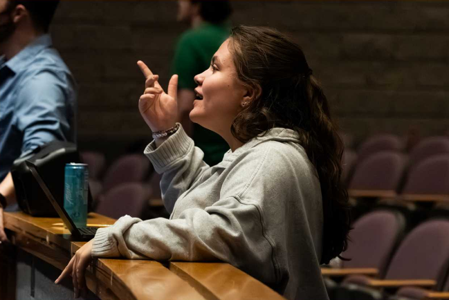 Senior Bailey Gilbert manages a run-through of Hello, Dolly!